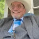 Smiling man in cowboy hat and suit