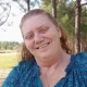 Smiling woman in blue blouse outdoors