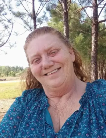 Smiling woman in blue blouse outdoors
