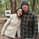 Elderly couple smiling at wooded campsite