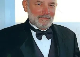 Older man in black tuxedo and bow tie