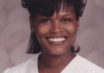 Smiling woman in white blouse studio portrait