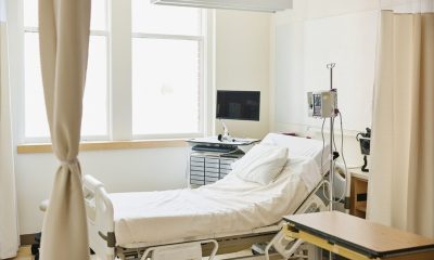 Empty hospital room with bed and medical equipment