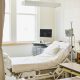 Empty hospital room with bed and medical equipment