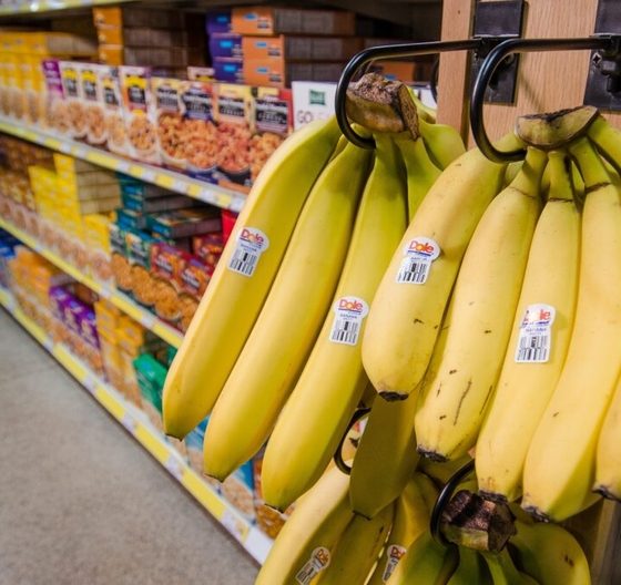 Bananas hanging in grocery store produce section — Medicaid meal delivery Northwest Florida