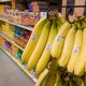 Bananas hanging in grocery store produce section