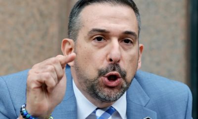 Man in suit speaking and pointing finger