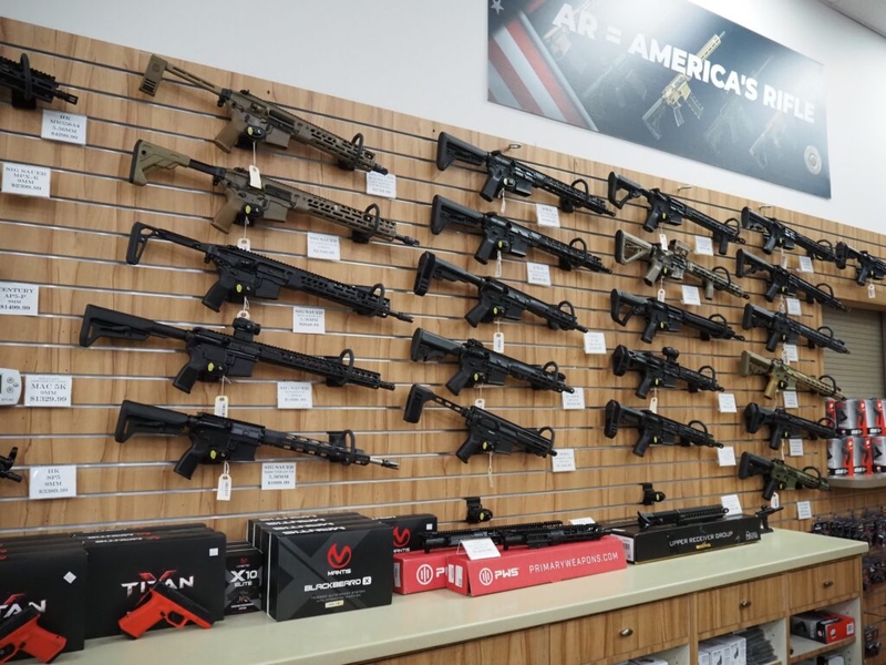 Wall display of AR-style rifles in gun shop