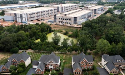Industrial warehouse complex behind suburban neighborhood homes