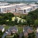 Industrial warehouse complex behind suburban neighborhood homes
