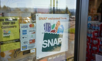 Store window sign showing SNAP accepted here