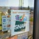 Store window sign showing SNAP accepted here