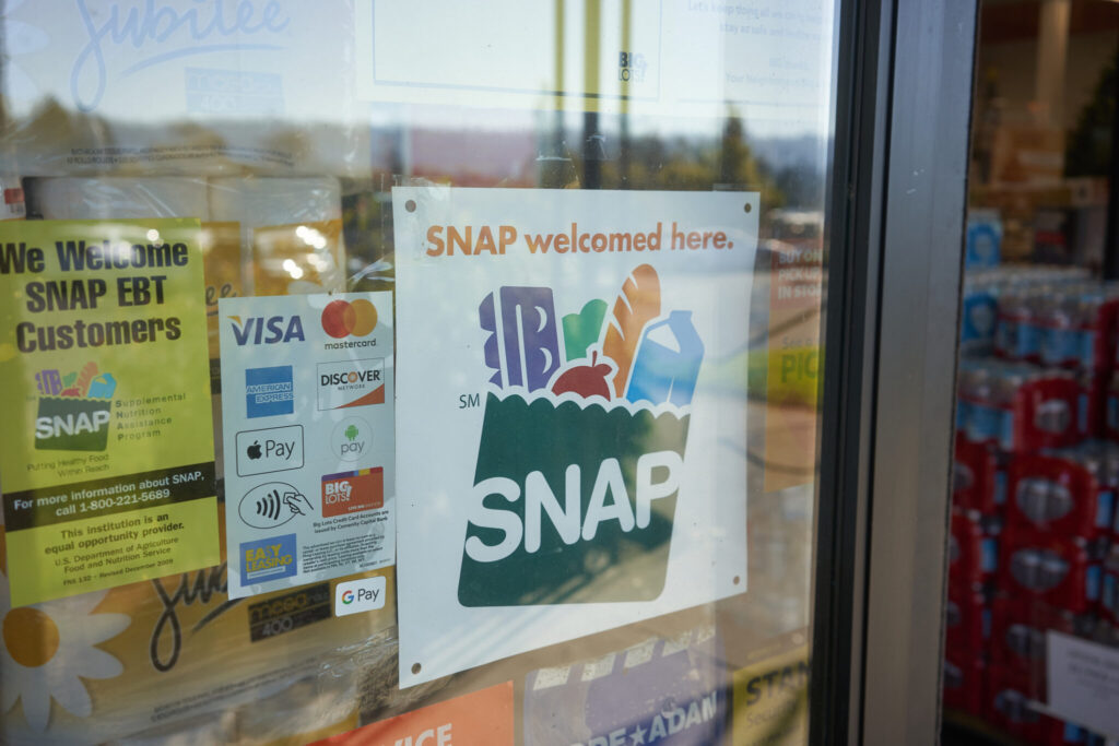 Store window sign showing SNAP accepted here