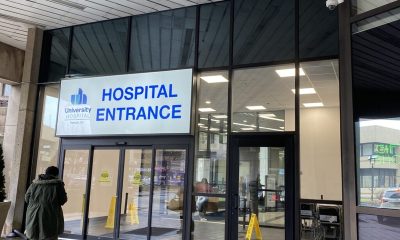 Hospital entrance with glass doors and signage