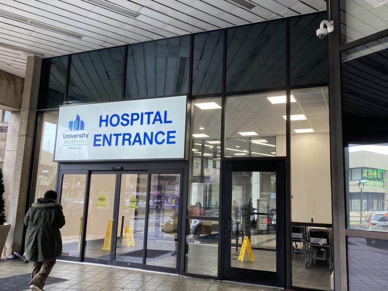 Hospital entrance with glass doors and signage