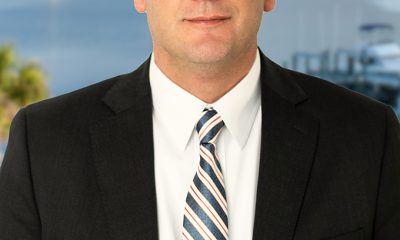 Man in suit and glasses by waterfront