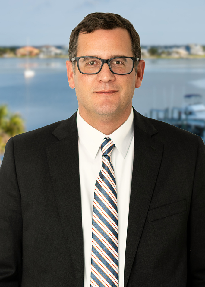 Man in suit and glasses by waterfront