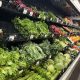 Grocery store produce aisle with fresh vegetables