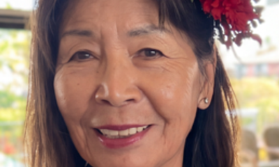 Smiling woman with red flower in hair