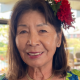 Smiling woman with red flower in hair