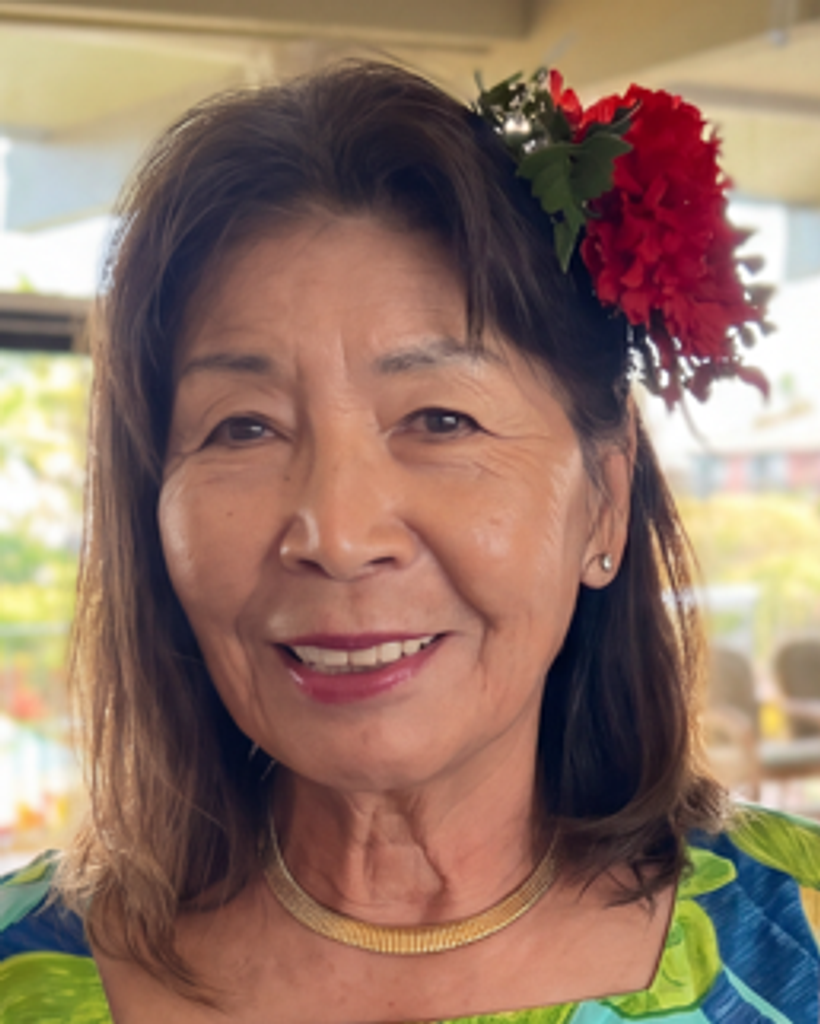 Smiling woman with red flower in hair