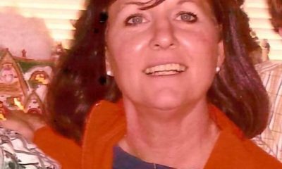 Smiling woman indoors with holiday decorations