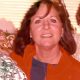 Smiling woman indoors with holiday decorations