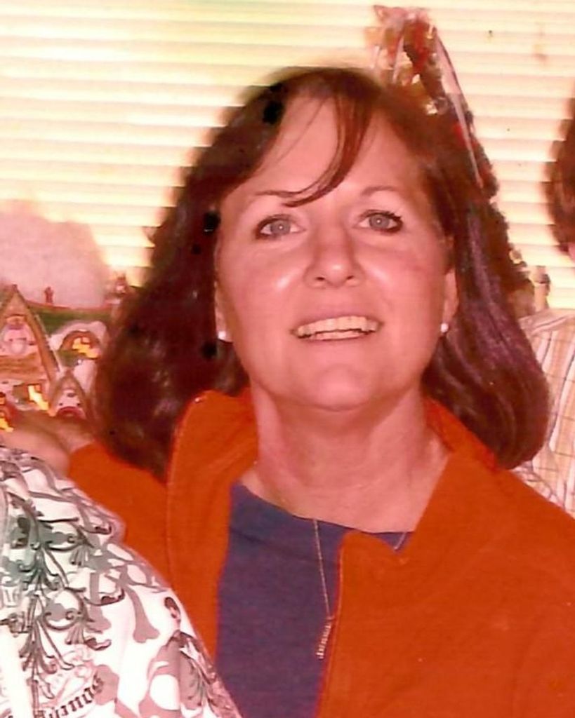 Smiling woman indoors with holiday decorations