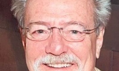 Smiling older man with glasses and white beard