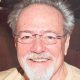 Smiling older man with glasses and white beard