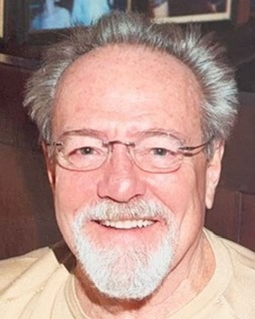 Smiling older man with glasses and white beard