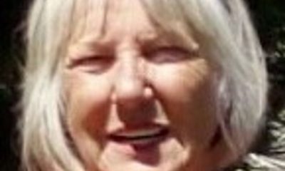 Smiling older woman with gray bob haircut outdoors