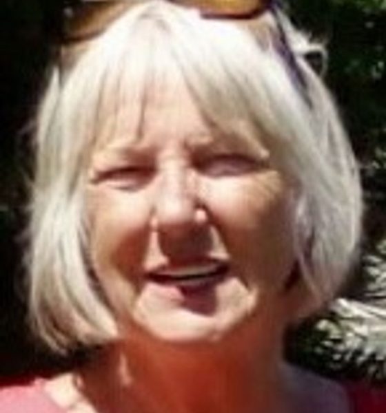 Smiling older woman with gray bob haircut outdoors