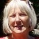 Smiling older woman with gray bob haircut outdoors