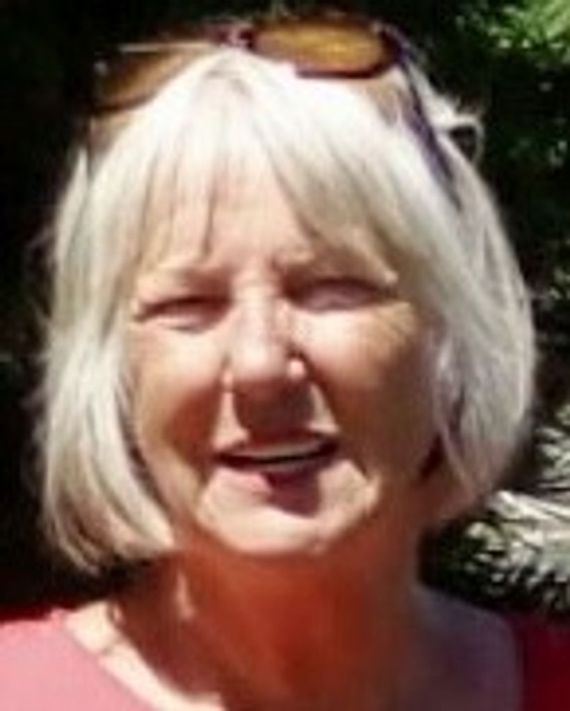 Smiling older woman with gray bob haircut outdoors