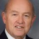 Portrait of older bald man in suit and tie