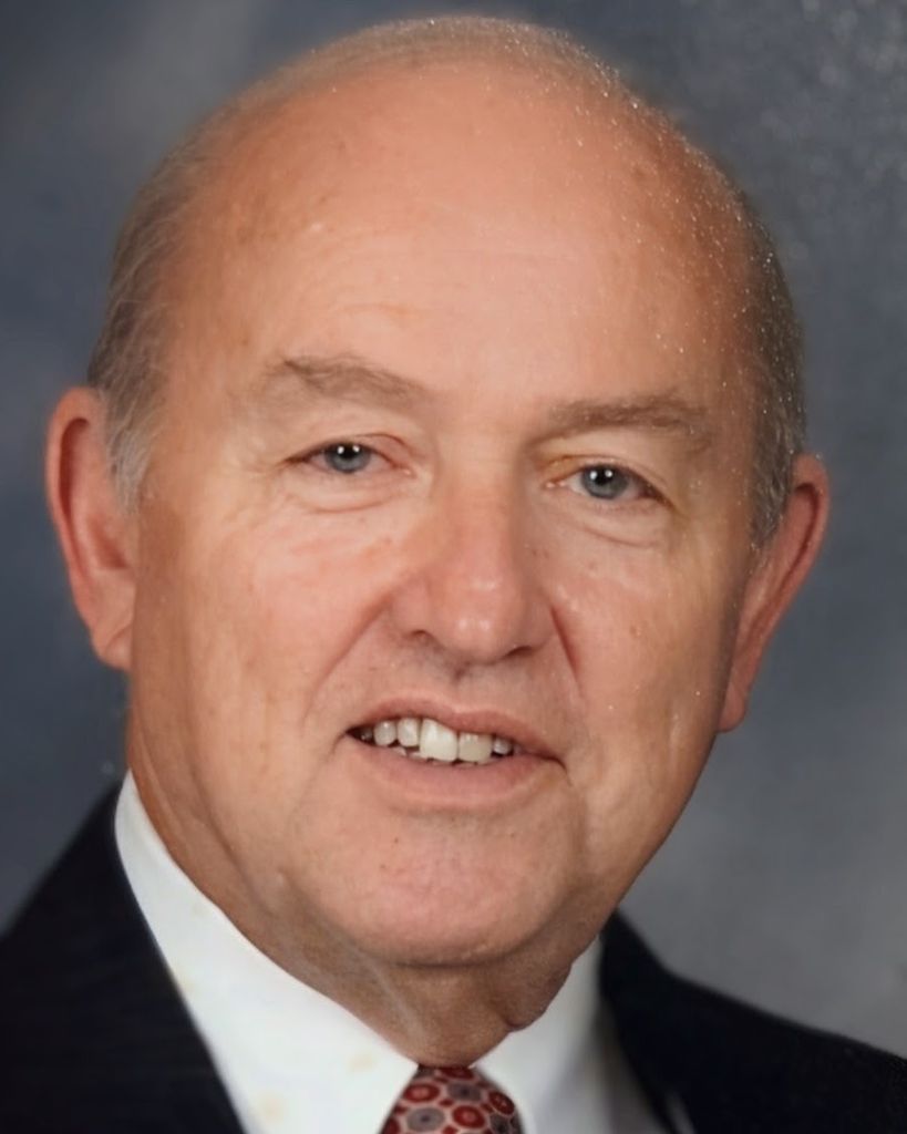Portrait of older bald man in suit and tie