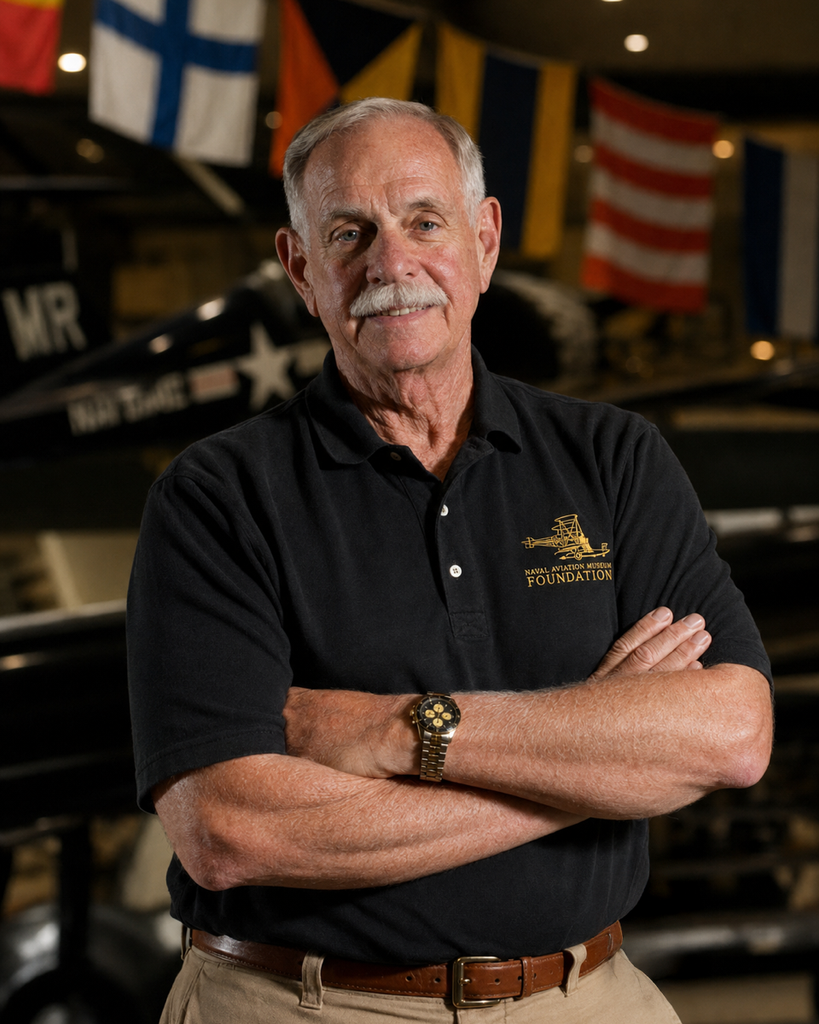 Man in Naval Aviation Museum polo indoors