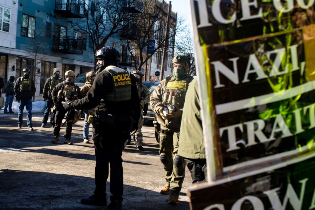 Border Patrol officers standing on city street