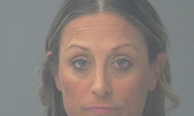 Woman with neutral expression against gray background