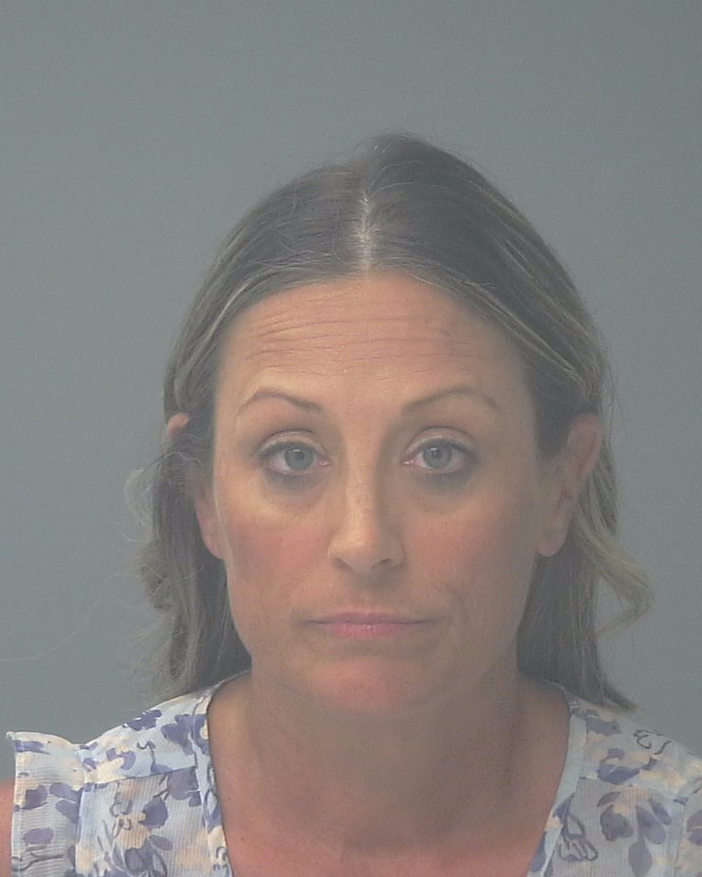 Woman with neutral expression against gray background