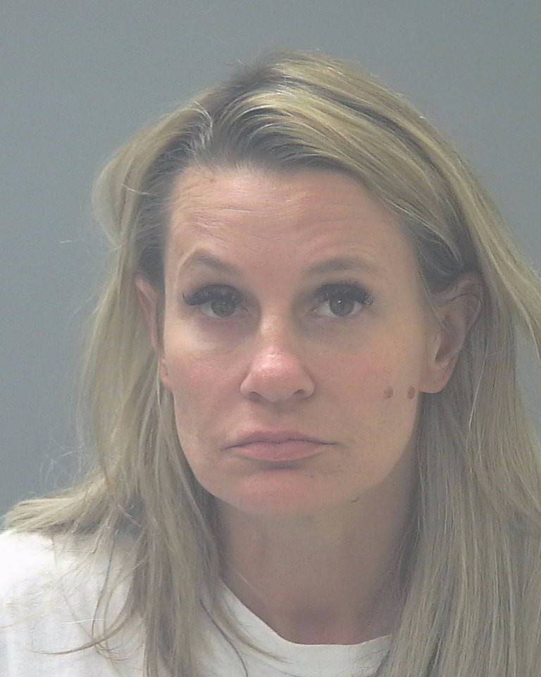 Portrait of blonde woman against plain background