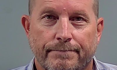 Bald man with beard in striped shirt
