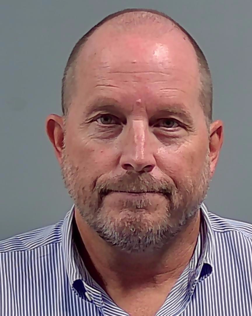 Bald man with beard in striped shirt