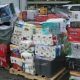 Shrink-wrapped pallets of assorted household goods outdoors