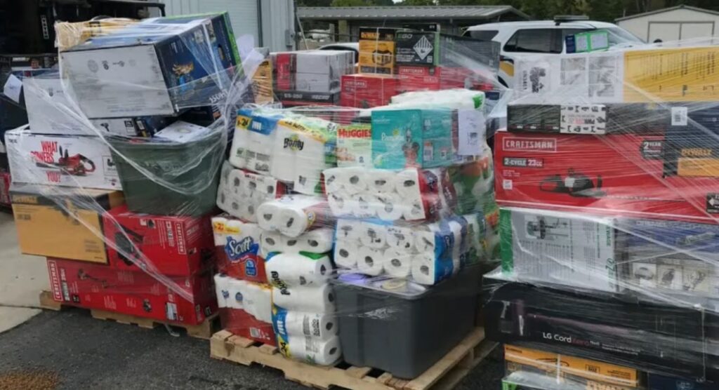 Shrink-wrapped pallets of assorted household goods outdoors