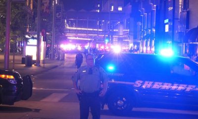 Police officer by sheriff SUV at night