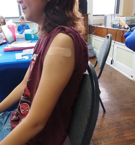 Child with bandage after vaccination indoors