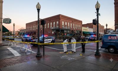 Police investigate downtown crime scene at dusk