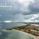 Storm clouds over coastal shoreline with lighthouse